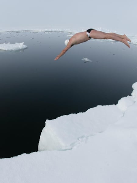 Lewis Pugh jumping into the icy cold water of the North Pole during his historic first long-distance swim at the top of the wolrd
