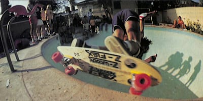 An iconic poolriding shot of Jimmy Plumer from the pages of Skateboarder magazine.