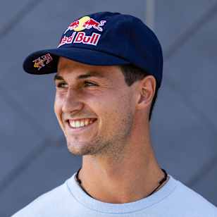 Freeski pro Max Hitzig stands ready for a portrait photo with a Red Bull can in his hand.