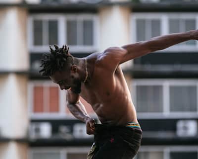 Nigerian dancer Blayke pictured performing in front of a building.