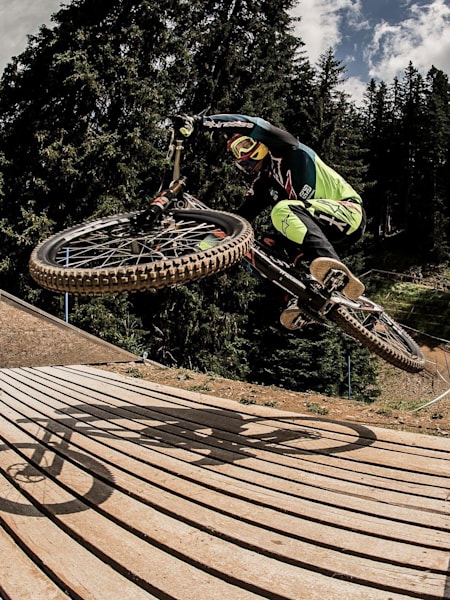 Aaron Gwin rides the bridge jump performs at Lenzerheide World Cup DH Finals in Switzerland on July 8, 2017