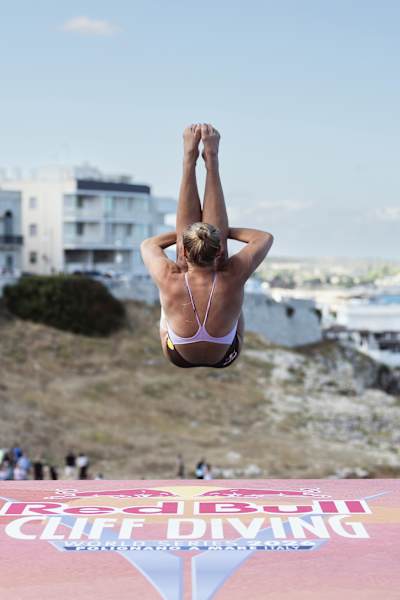 Rhiannan Iffland of Australia launches from the 22-metre platform at the 2026 Red Bull Cliff Diving World Series final stop in Polignano a Mare, Italy