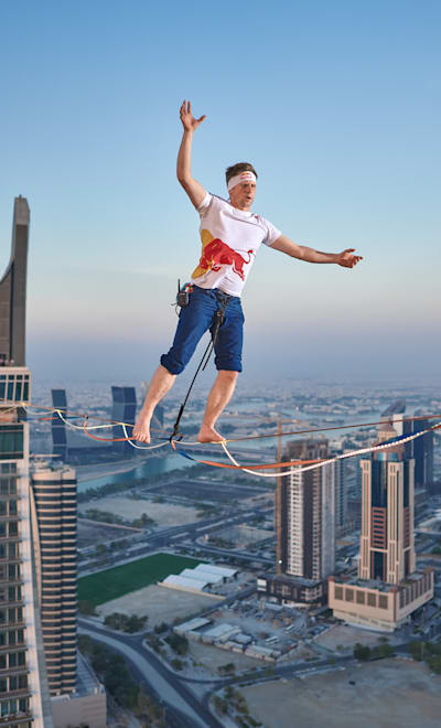 Jaan Roose slacklining between Crescent building Towers in Doha, Qatar on June 19, 2023.