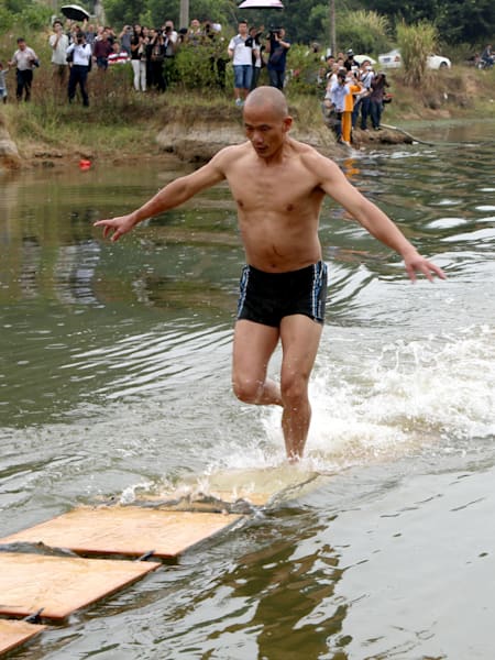 Amazing Chinese Shaolin Monk Shi Liliang during his walk on water stunt in Quanzhou, China 
