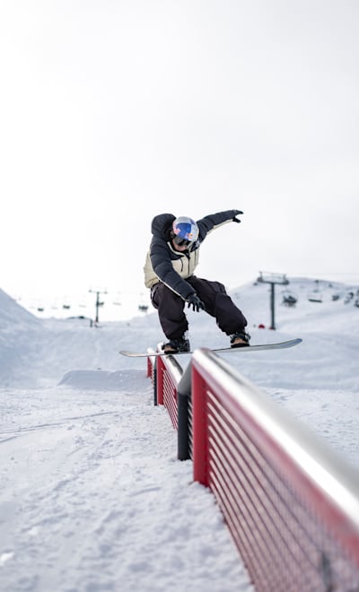 In 2024, snowboarder Txema Mazet-Brown rides a rail at Cardrona, New Zealand.