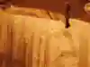 A man walks next to a pool of water