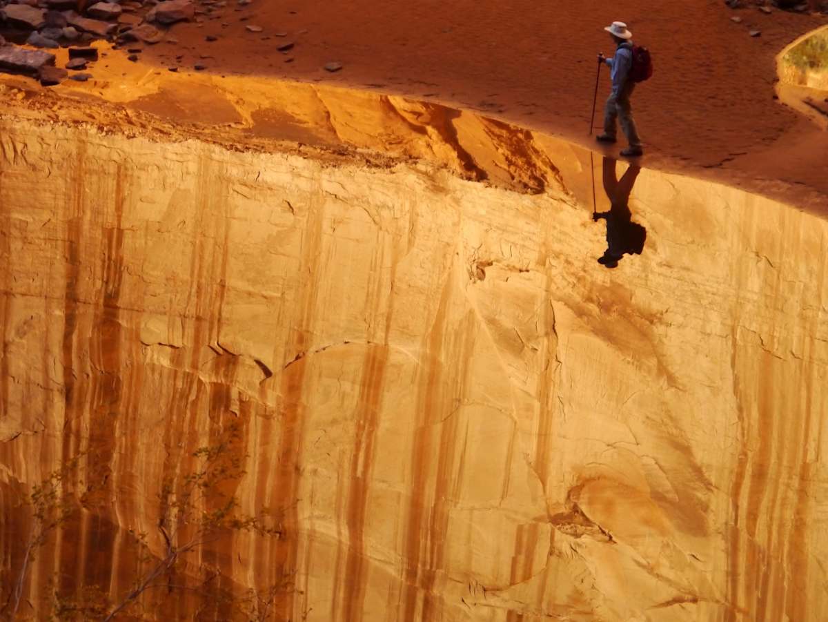 A man walks next to a pool of water