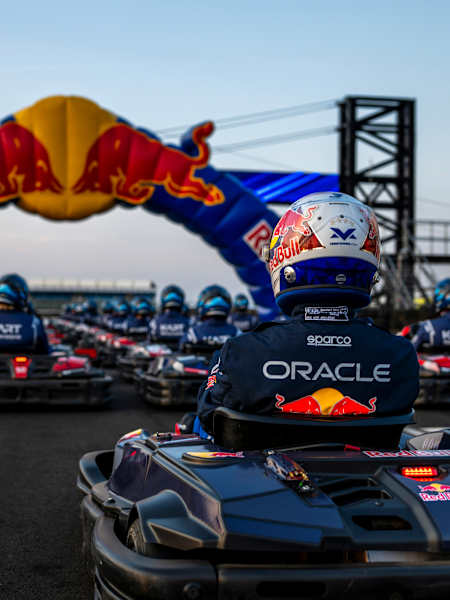 Competitors line up in karts beneath the Red Bull arch during the launch of Max vs 100 at Silverstone, Great Britain, in July 2026.