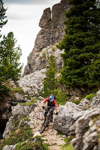 A mountain biker testing his technical descending skills in Südtirol.