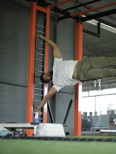 Kochi fitness trainer Nipun Viju performs calisthenics exercises in a gym.