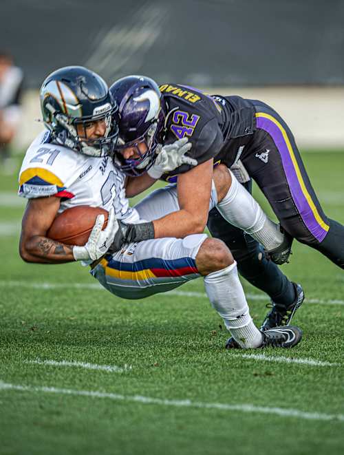 A Vienna Vikings player tackles a Berlin Thunder player for the football at the May 23, 2026 American Football League Europe game in Vienna, Austria