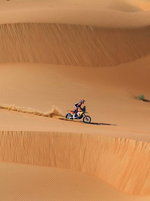 Daniel Sanders of the KTM Red Bull Factory Racing Team powers through desert dunes in Stage 11 of Dakar 2025 near Subaytah, Saudi Arabia, showcasing Red Bull's relentless off-road spirit
