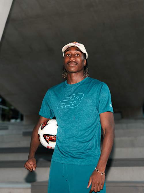 Yan Diomandé poses with a football during a portrait photoshoot in Saalfelden, Austria, in 2026, wearing New Balance apparel.