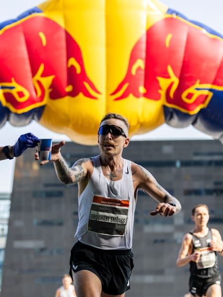 Runners racing under an inflatable Red Bull arch during the Copenhagen Half Marathon in Denmark.