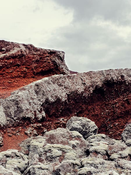 An ultrarunner runs over a rocky ridge in Iceland