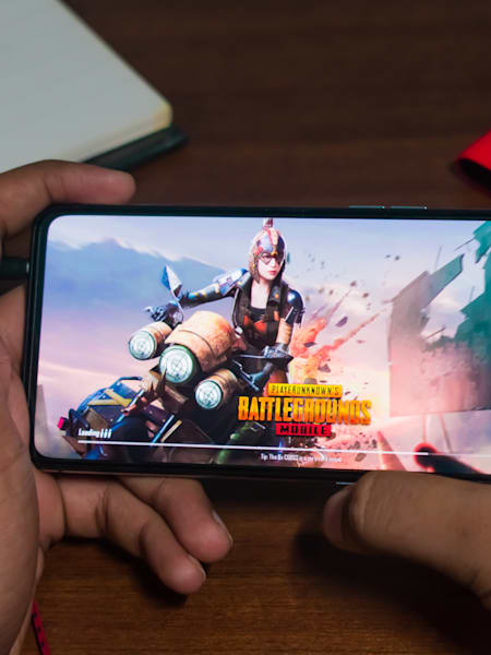 A gamer plays PUBG Mobile on a realme phone.