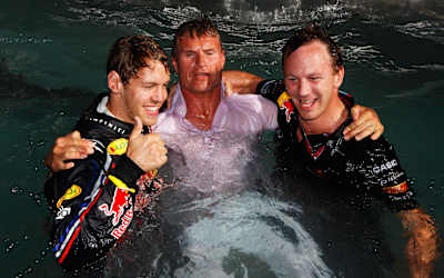 A photo of Sebastian Vettel, Christian Horner and David Coulthard in the Red Bull Racing Energy Station swimming pool after the 2011 Monaco Grand Prix.