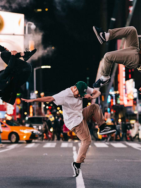Dancers Abel, Wingzero and Issei captured in an action shot on New York's Times Square by photographer Little Shao.