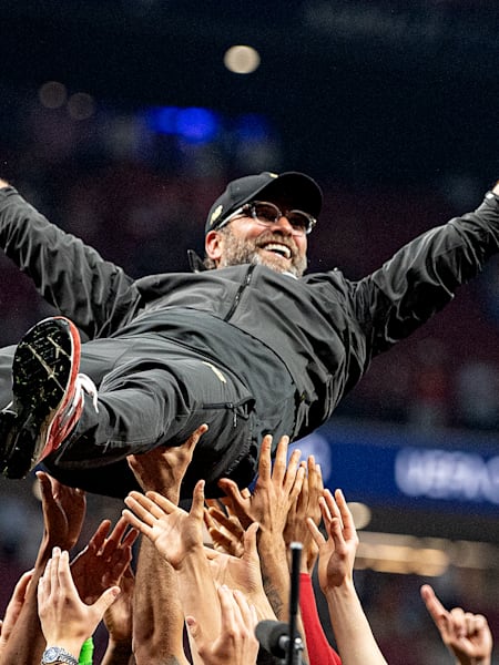 Jürgen Klopp is lifted up as Liverpool celebrate winning the UEFA Champions League in Madrid.