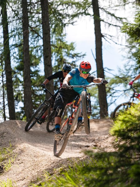 MTB riders have fun on a trail in the Carinthia region of Austria.