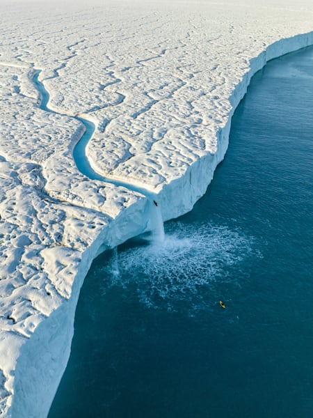 Aniol Serrasolses paddles the river on the Austfonna ice cap, Svalbard, Norway, on August 6, 2023