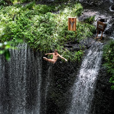 Matt Cooper of the USA dives from the 16.5 metre waterfall during the first competition day of the fourth stop of the Red Bull Cliff Diving World Series in Takachiho, Japan on August 2, 2023.