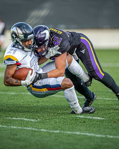 A Vienna Vikings player tackles a Berlin Thunder player for the football at the May 23, 2026 American Football League Europe game in Vienna, Austria