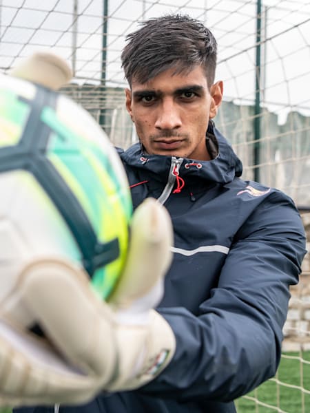 Indian football goalkeeper Gurpreet Singh Sandhu holds a ball during a training session.