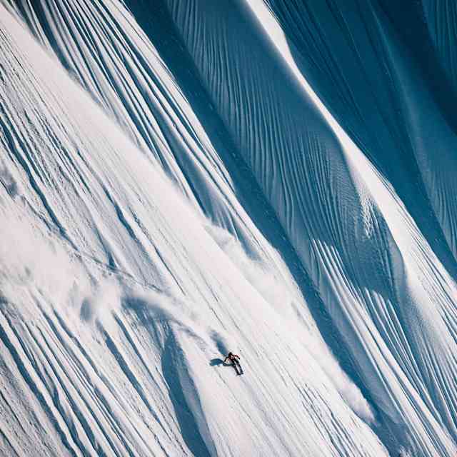 In 2023, Michelle Parker skis down mesmerizing snow patterns in Girdwood, AK for Red Bull Illume. © Katie Lozancich / Red Bull Illume