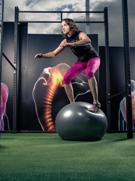 Ejercicios en el gimnasio sobre una pelota de equilibrio.
