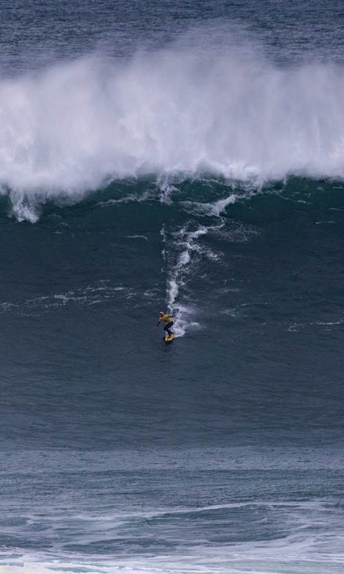 Justine Dupont of France surfs in Heat 1 - Group A of Session One at the TUDOR NAZARÉ Big Wave Challenge on February 18, 2025, at Nazaré, Portugal.