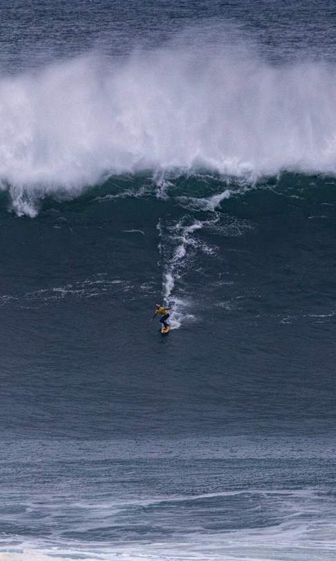 Justine Dupont of France surfs in Heat 1 - Group A of Session One at the TUDOR NAZARÉ Big Wave Challenge on February 18, 2025, at Nazaré, Portugal.