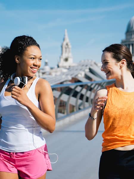 Two women go for a jog across the Millennium Bridge in London, UK.