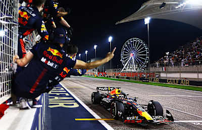 BAHRAIN, BAHRAIN - MARCH 05: Race winner Max Verstappen driving the Red Bull Racing RB19 passes his team celebrating on the pitwall during the F1 GP of Bahrain. (Photo by Mark Thompson/Getty Images)