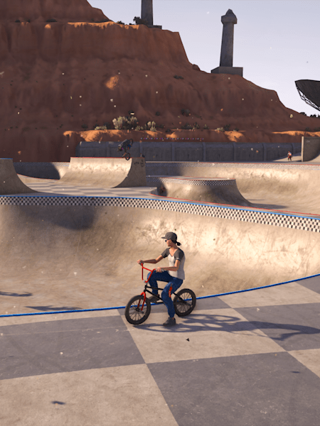 A BMX rider sits alongside a BMX park bowl in Riders Republic