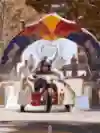 A Red Bull branded cart races through a fiery arch at the Red Bull Billy Cart event in Melbourne, Australia, 2022