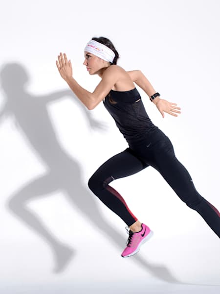 woman running in front of a white wall