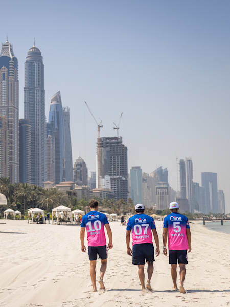 Players of Rajasthan Royals walk on a beach during the team's 2020 jersey launch