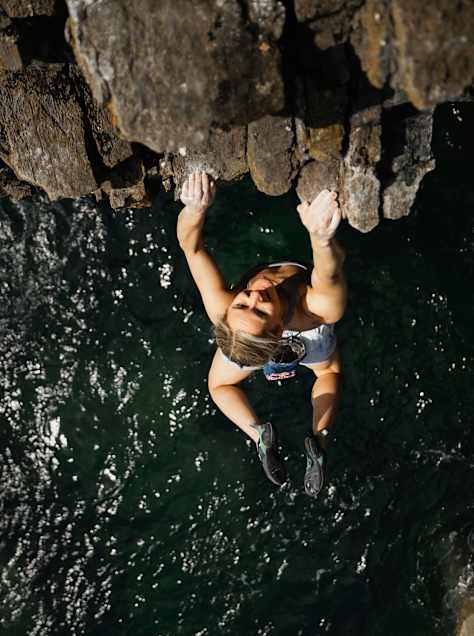 British climber Shauna Coxsey climbs the deep-water solo route Olympiad above the sea in Pembrokeshire, Wales.