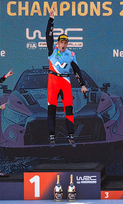 Thierry Neuville and Martijn Wydaeghe celebrate on the podium after winning the FIA World Rally Championship season during the World Rally Championship in Toyota City, Japan.