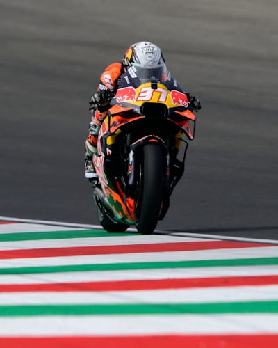 Pedro Acosta powers the Red Bull KTM Factory Racing bike on the Mugello circuit during the 2025 MotoGP World Championship, showcasing speed and energy on Italian asphalt