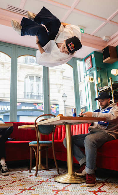 Lilou Ruel jumps in a french brasserie in Paris, France in June 2024.