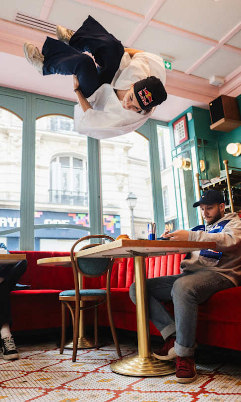 Lilou Ruel jumps in a french brasserie in Paris, France in June 2024.