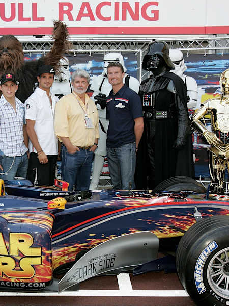 Christian Klien, Vitantonio Liuzzi and David Coulthard alongside Star Wars film director George Lucas, in the Red Bull Racing team garage during the previews for the Monaco F1 GP on May 20, 2005.
