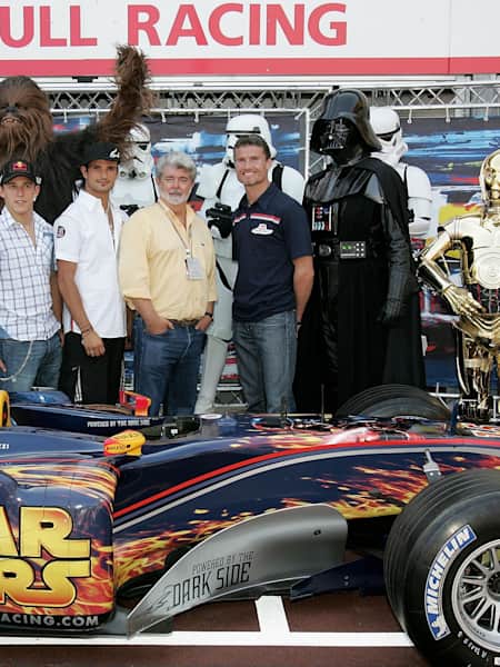 Christian Klien, Vitantonio Liuzzi and David Coulthard alongside Star Wars film director George Lucas, in the Red Bull Racing team garage during the previews for the Monaco F1 GP on May 20, 2005.