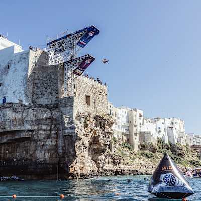 A cliff diver dives off a board in Poligniano a Mare, Italy.