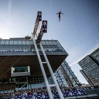 Cătălin Preda of Romania leaps from the 27-metre platform atop Boston’s Institute of Contemporary Art during the dynamic Red Bull Cliff Diving World Series final stop on 20 September 2025