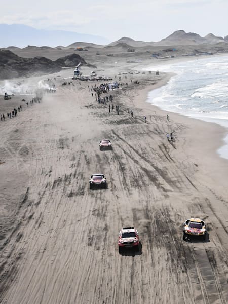 Despres, Sainz, Peterhansel in the Peugeot 3008 DKR Maxi of the Team Peugeot Total Al-Attiyah in the Toyota Hilux of the Toyota Gazoo Racing racing in the beach during stage 4 of the Dakar Rally.