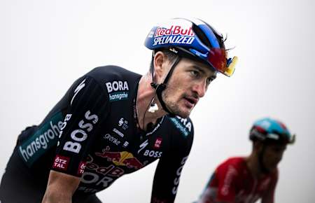 Nico Denz from Red Bull - BORA - hansgrohe ascends the challenging Cuitu Negru climb during stage 15 of La Vuelta 2024, showcasing determination in the Spanish mist