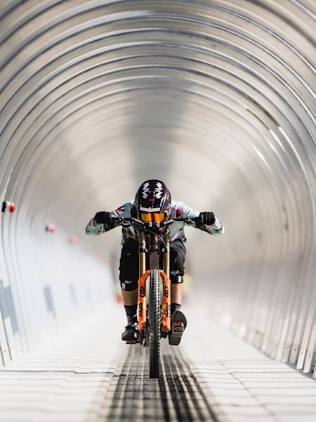 Reece Potter rueda por un túnel en el Skyline Bike Park de Queenstown, Nueva Zelanda.